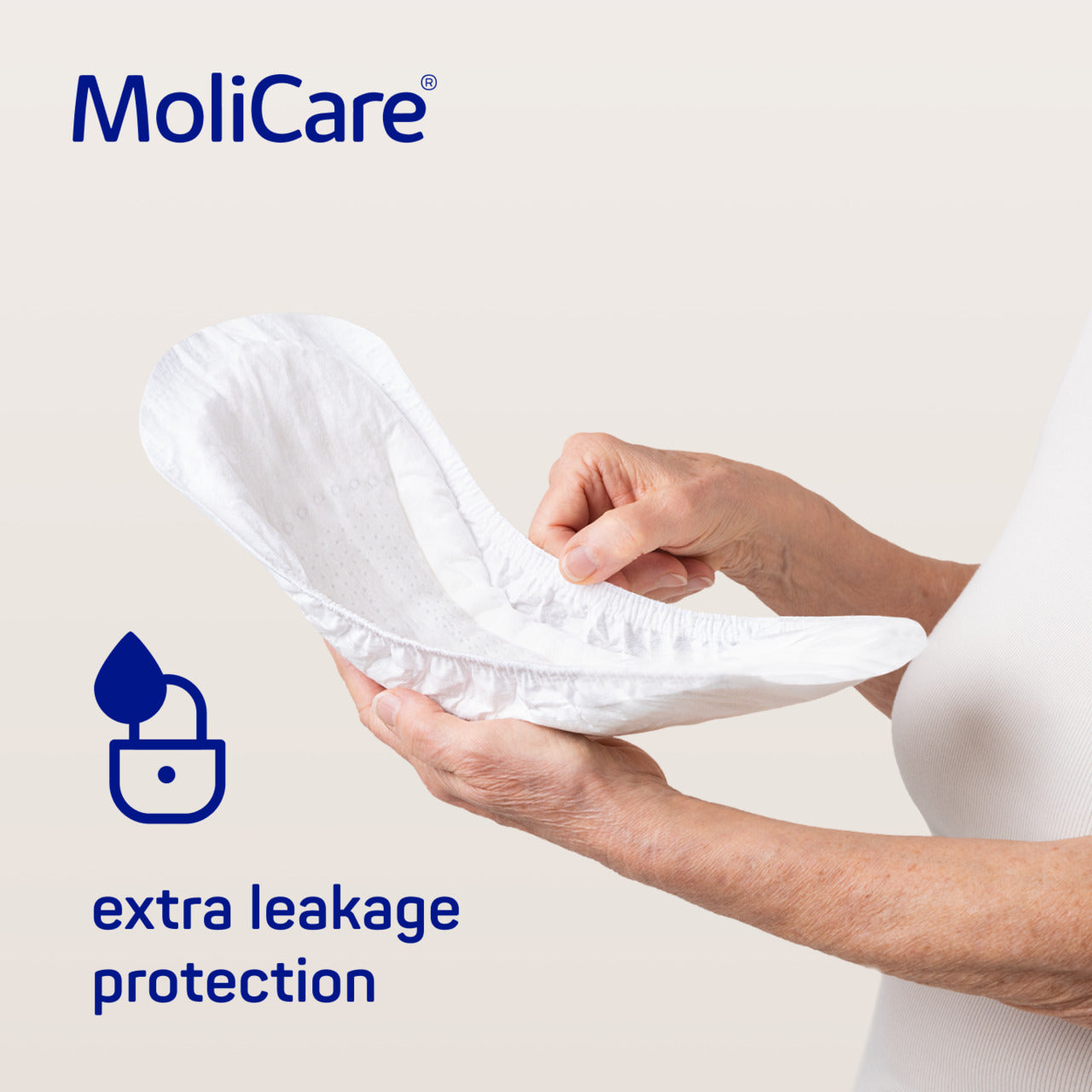 MoliCare product with a hand holding it, emphasizing extra leakage protection on a light background.