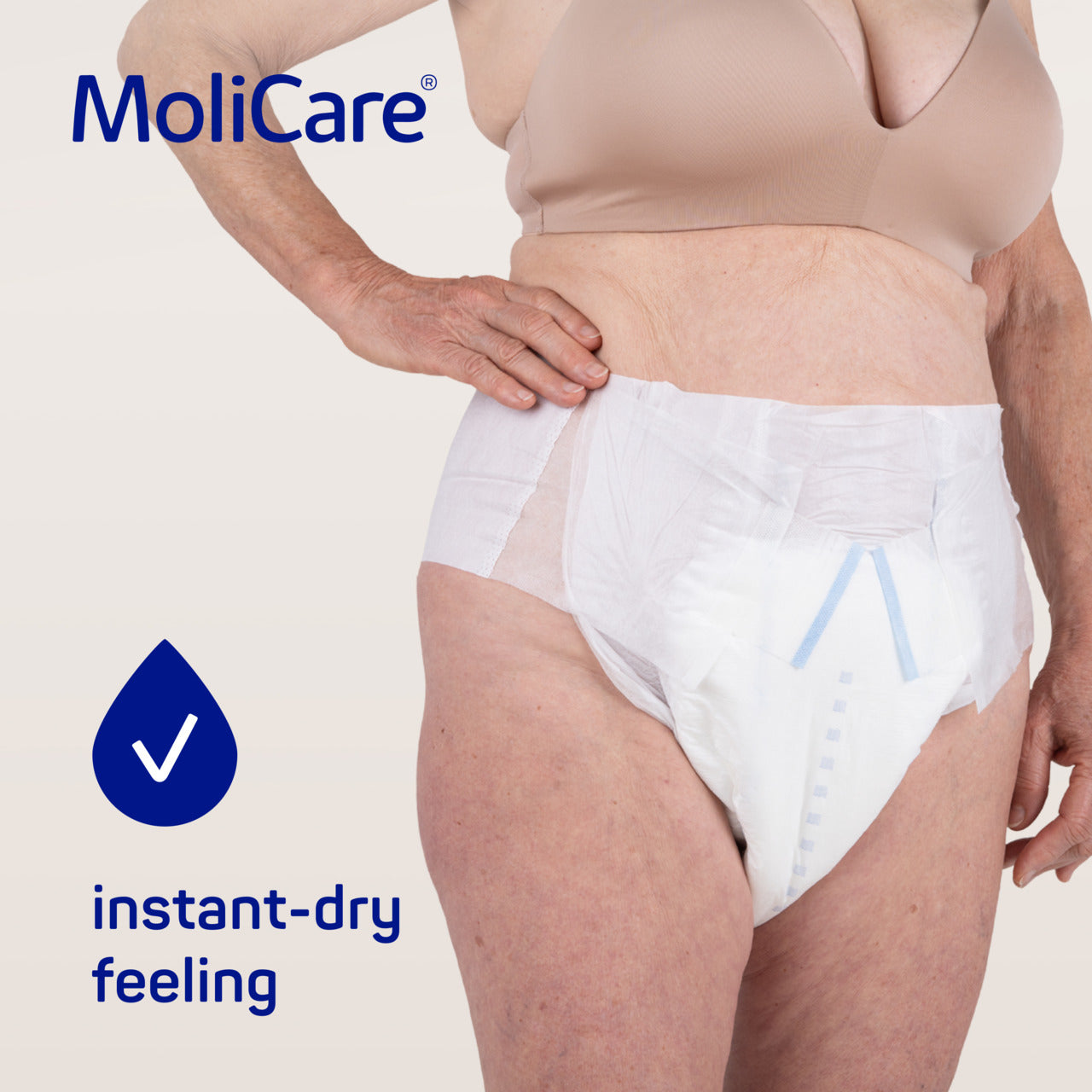Person wearing MoliCare adult diaper with 'instant-dry feeling' text and logo on a light background
