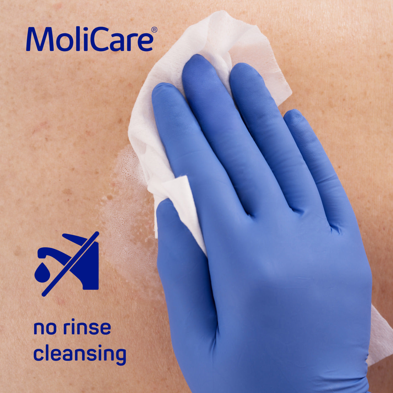 Hand wearing a blue glove cleaning with a MoliCare product on a beige background