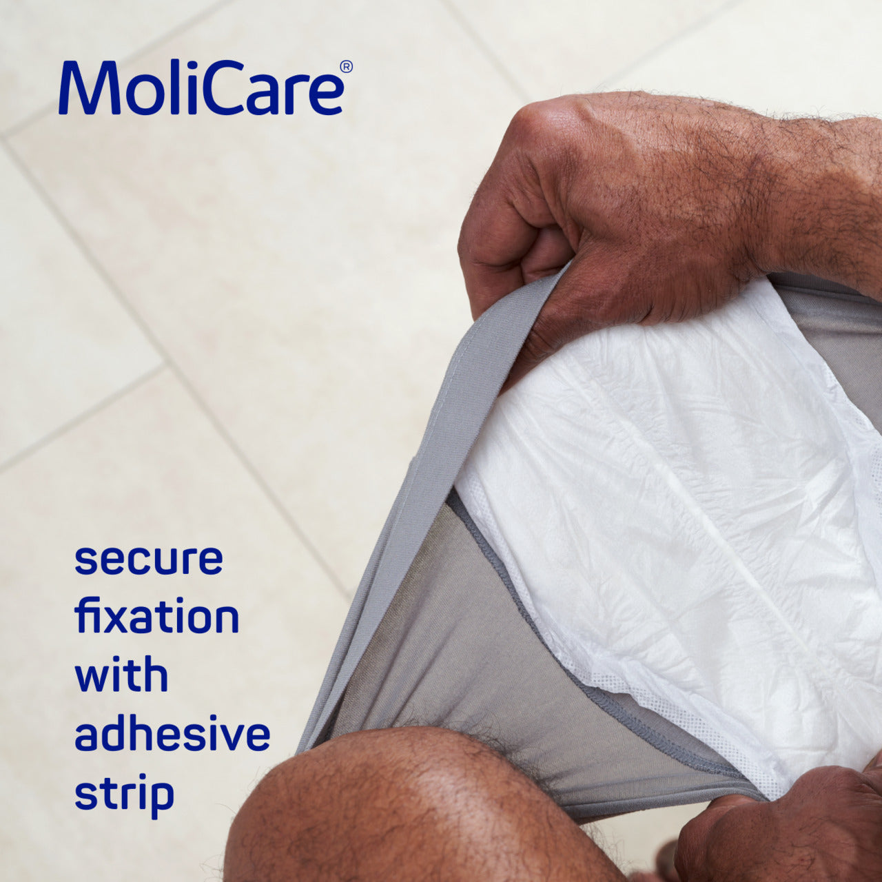MoliCare adhesive strip being applied to a person's skin