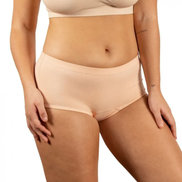 Beige underwear worn by a person on a white background