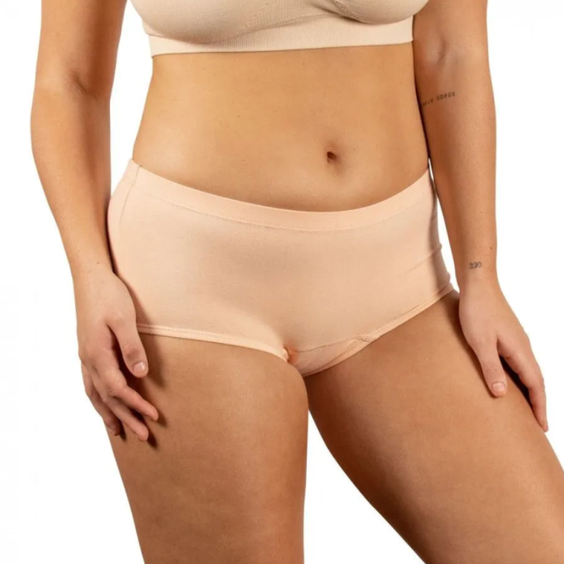 Beige underwear worn by a person on a white background