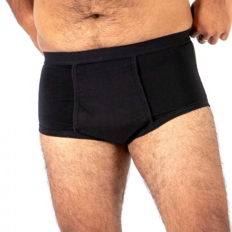 Black boxer briefs worn by a person on a white background