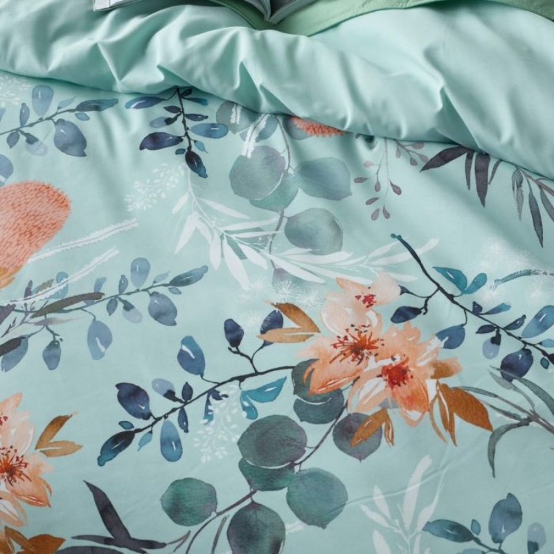 Floral patterned fabric with flowers and leaves on a light blue background