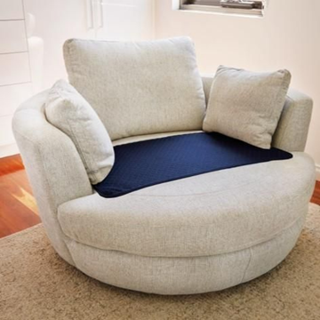 Round beige chair with a blue cushion on a carpeted floor.