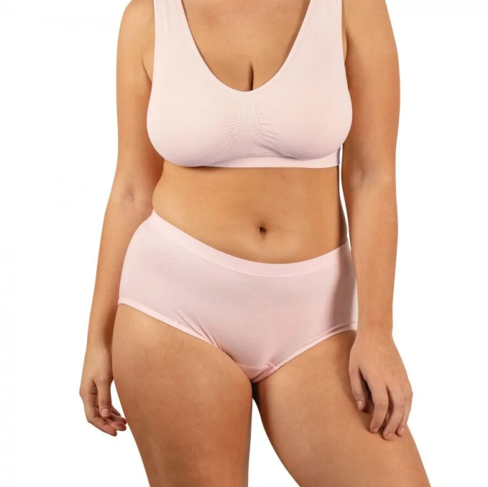 Woman wearing a light pink bikini set on a white background
