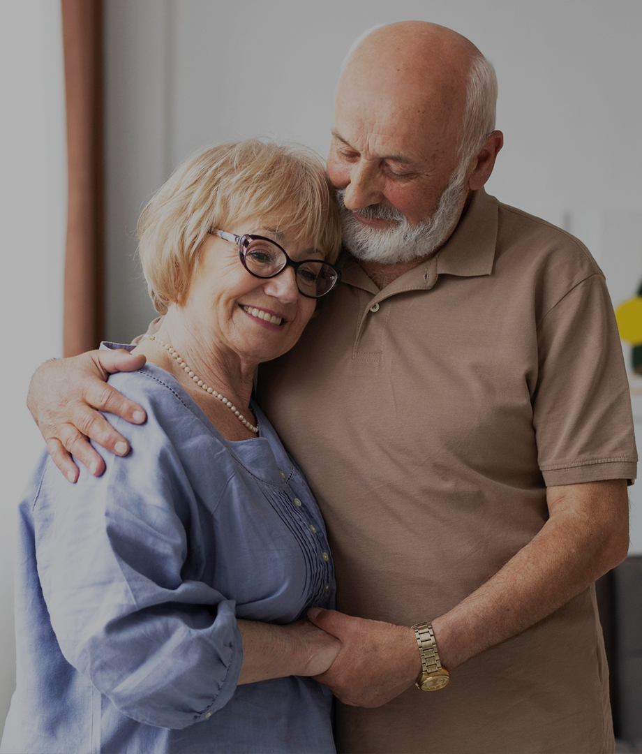 Senior couple embracing each other indoors