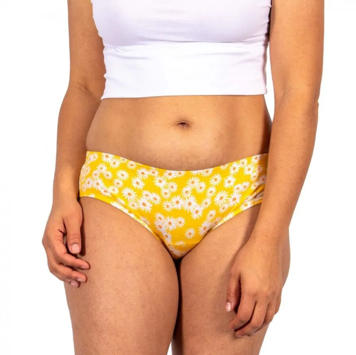 Person wearing yellow floral underwear and a white top on a white background