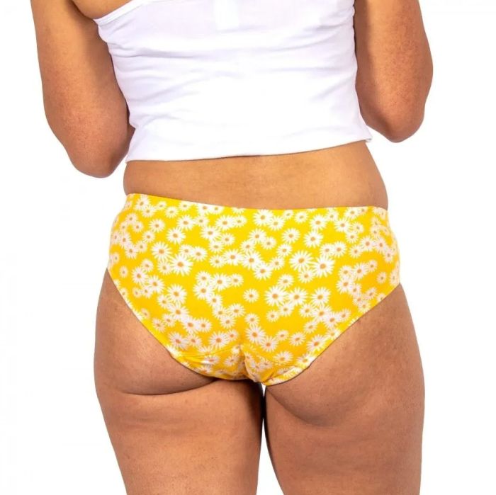 Yellow floral-patterned underwear worn by a person on a white background