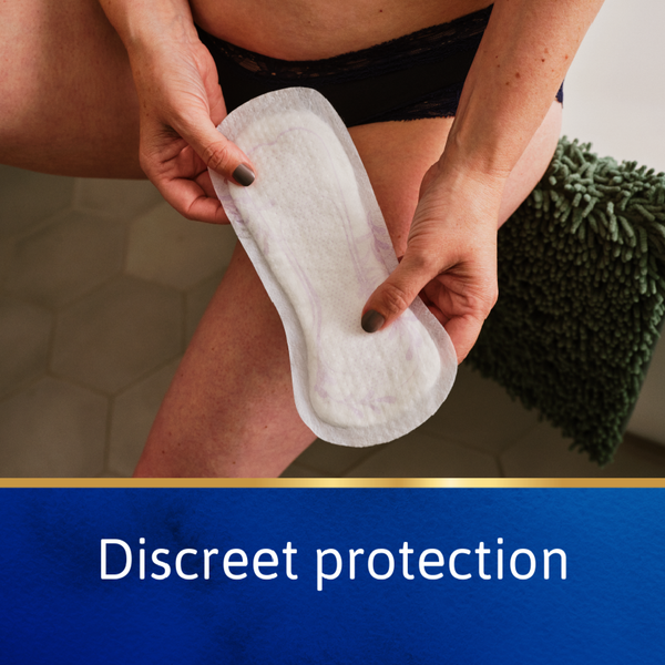Person holding a sanitary pad with text 'Discreet protection' at the bottom.